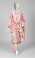 Mannequin wearing a pink embroidered outfit in a room with a painting and fireplace.