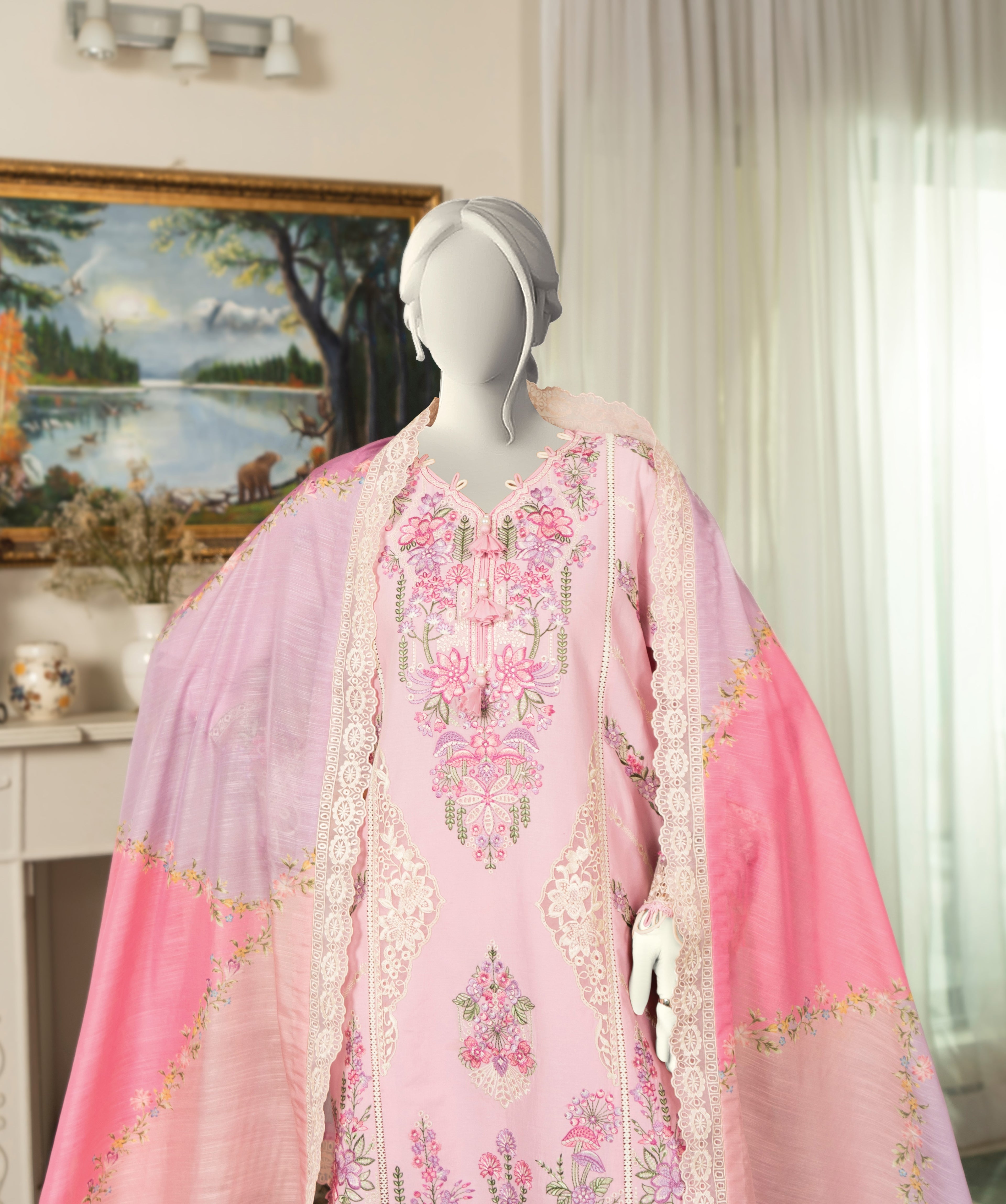 Mannequin wearing a pink embroidered outfit with a purple dupatta in a room setting.