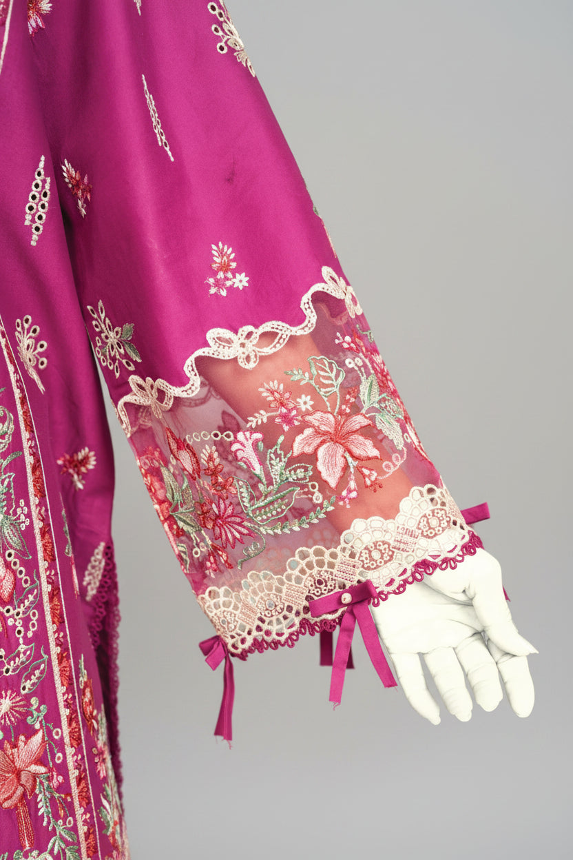 Close-up of a purple embroidered garment with a white glove, blurred background