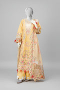 Mannequin wearing a yellow floral dress in an outdoor setting with trees and plants.