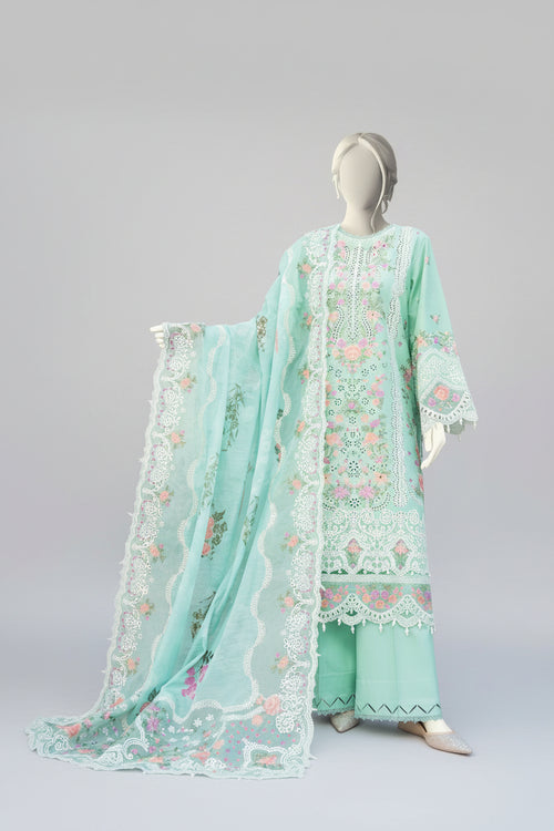 Light green embroidered outfit on a mannequin with a garden background