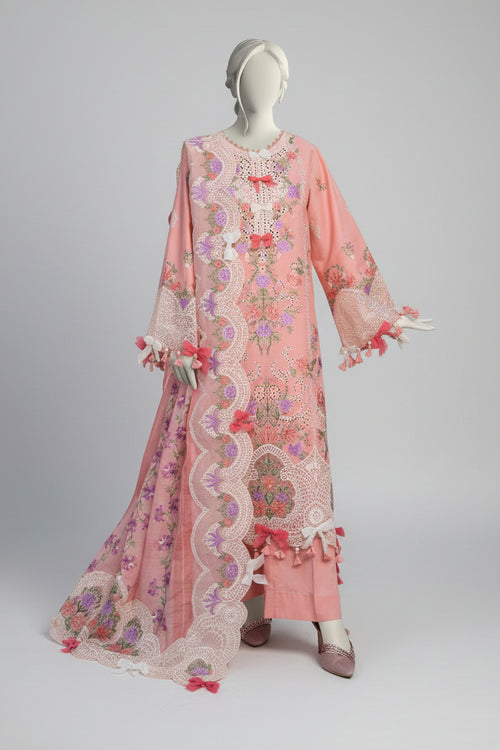 Mannequin wearing a pink embroidered outfit with a garden background