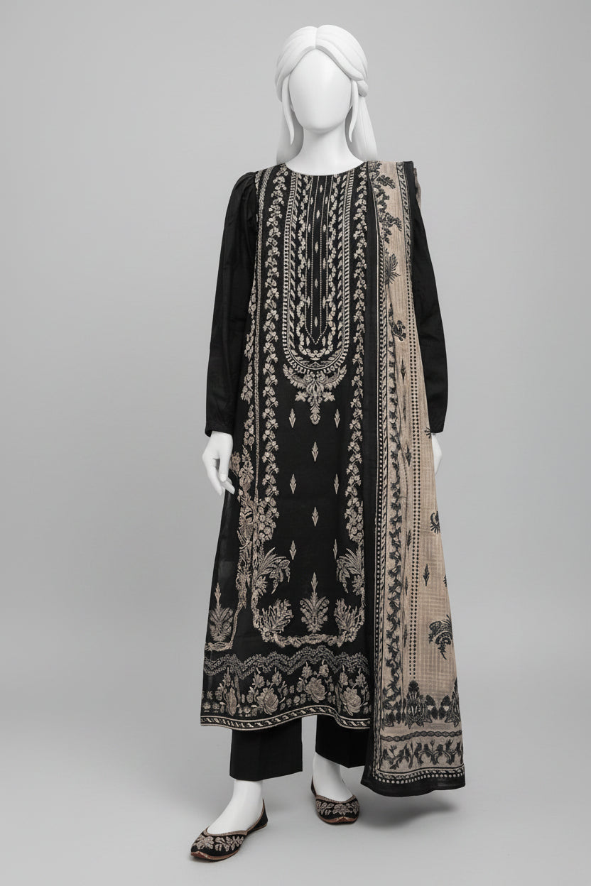 A black three-piece traditional outfit displayed on a mannequin in an outdoor courtyard with arches and potted plants. The set includes a long kurta with intricate silver embroidery, matching trousers, and a coordinating dupatta.