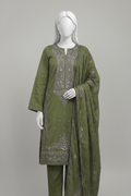 An olive green three-piece women's salwar kameez suit with silver-gray embroidery, displayed on a mannequin in a grand indoor hallway with a staircase.