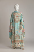 Mannequin wearing a long, ornate dress with floral patterns on a plain background