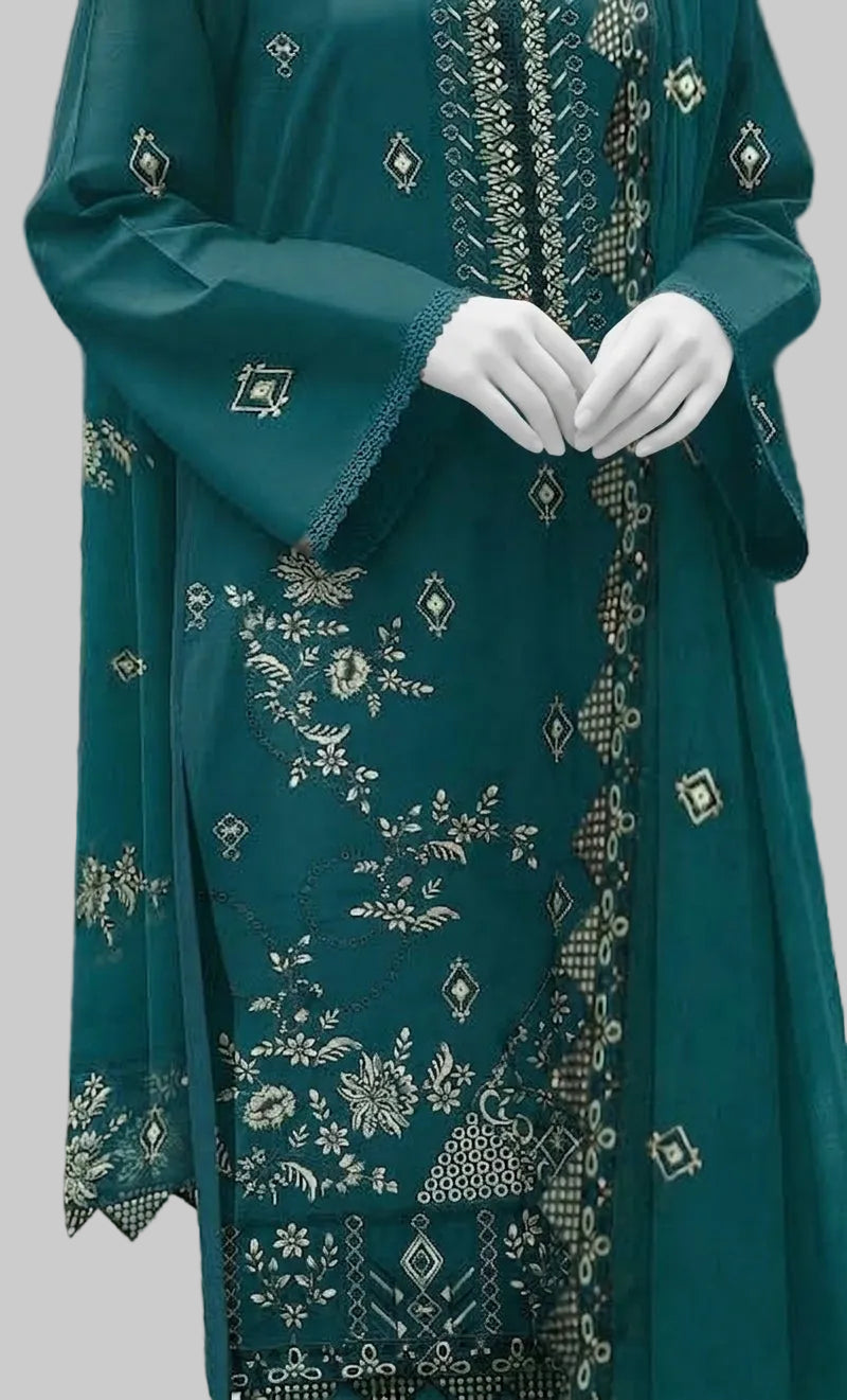 A teal green traditional embroidered dress with white gloves, featuring intricate silver and white floral embroidery and geometric patterns.