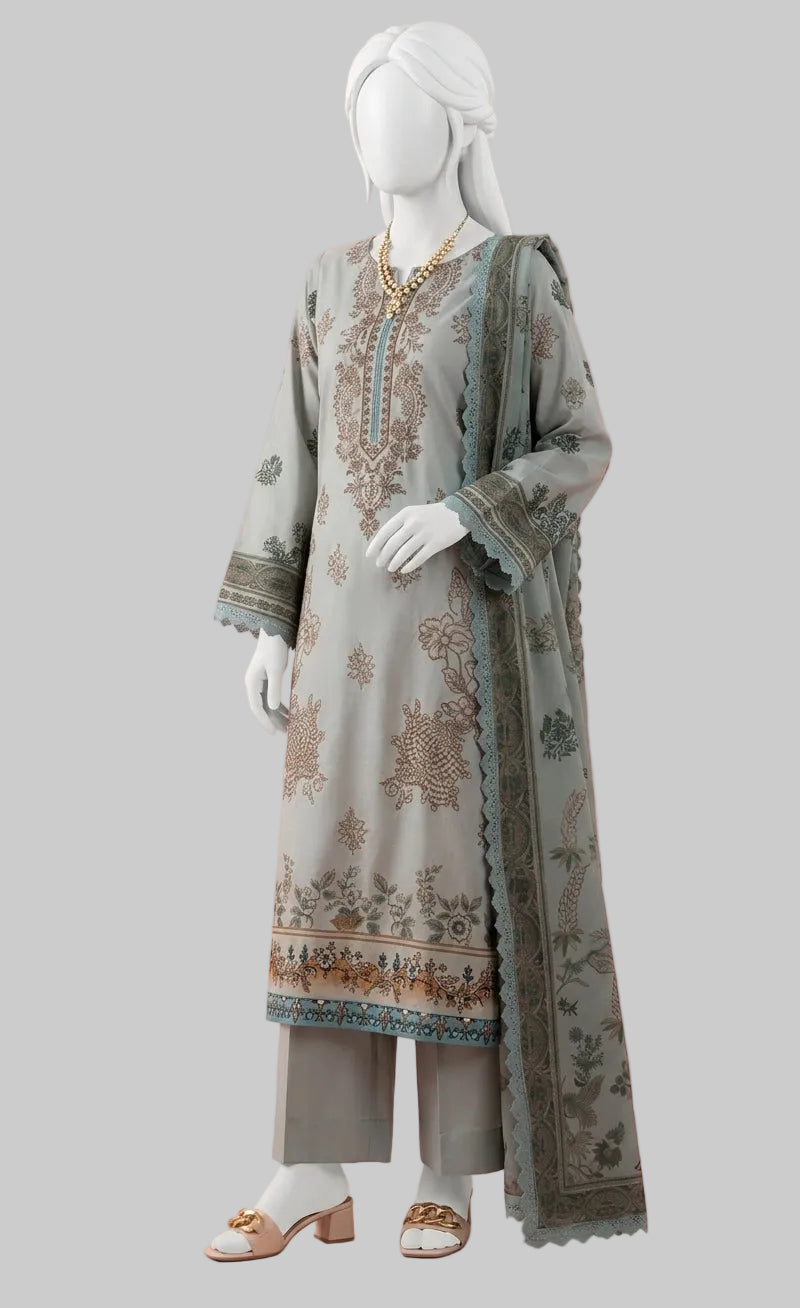 A three-piece women's traditional outfit displayed on a white mannequin against a solid pink background. The set includes a light gray-green kurta with brown and gold floral patterns and a matching dupatta, paired with gray trousers and white heeled sandals.