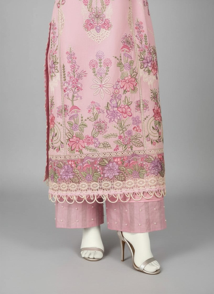 Pink embroidered traditional outfit with white shoes on a gray background