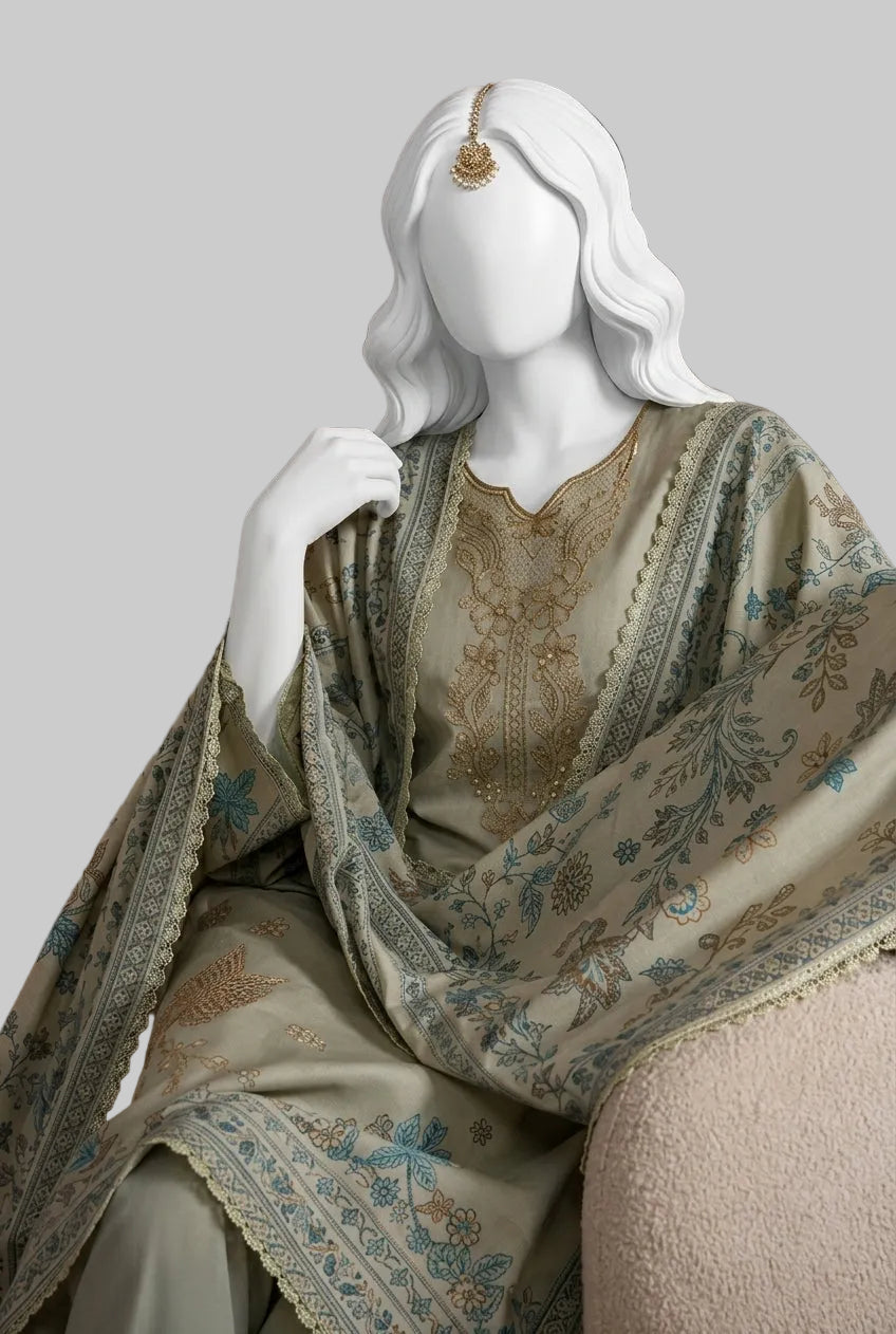 A white mannequin styled with a traditional embroidered outfit in beige, gold, and blue, posed against a patterned mauve wallpaper background.